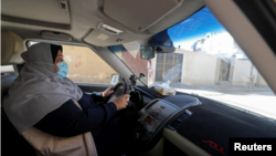 Palestinian woman Naela Abu Jibba, who started a women-only taxi service in the Gaza Strip, drives her vehicle at Beach refugee camp in Gaza City on November 17, 2020. (REUTERS/Mohammed Salem)