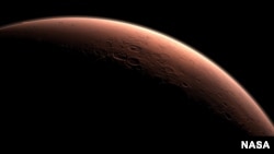 This computer-generated images depicts part of Mars at the boundary between darkness and daylight, with an area including Gale Crater, beginning to catch morning light. Northward is to the left. Gale is the crater with a mound inside it near the center of the image. NASA selected Gale Crater as the landing site for Curiosity. (NASA)