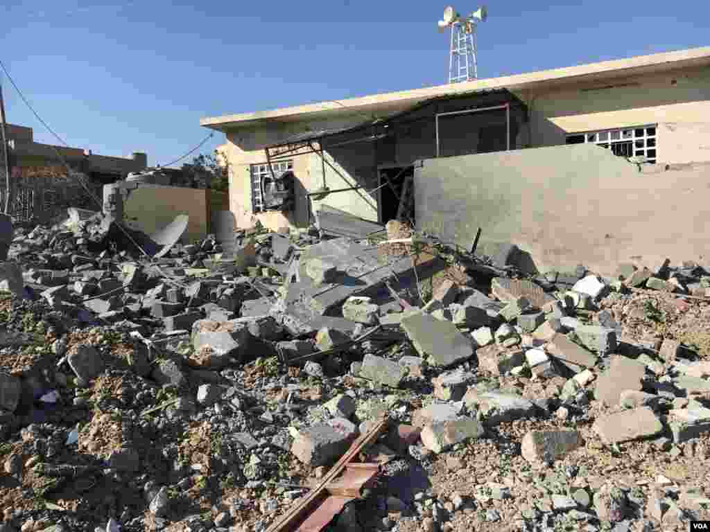 Rubble from a destroyed home litters the street in Abu Saif village, southwest Mosul, Feb. 23, 2017. (K. Omar/VOA)