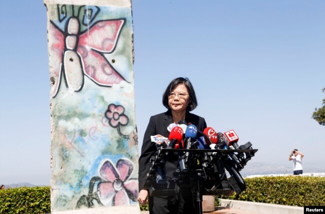Taiwanese President Tsai Ing-wen standing by a section of the Berlin Wall speaks to media at the Ronald Reagan Presidential Library in Simi Valley, California, Aug.13, 2018.