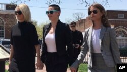 Actress Rose McGowan, flanked by lawyers Jennifer Robinson, left, and Jessica Carmichael, right, outside the Loudoun County courthouse in Leesburg, Virginia, May 3, 2018.