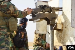 Peshmerga take aim at an IS position, Nov. 7, 2016. (J. Dettmer/VOA)