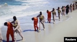 FILE - Islamic State militants force Ethiopian Christians along a beach in Libya in this undated image found on social media in April 2015.