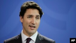 FILE - Prime Minister of Canada Justin Trudeau attends a news conference with German Chancellor Angela Merkel after talks at the chancellery in Berlin, Feb. 17, 2017. 