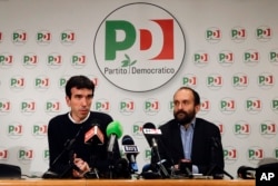 Democratic Party lawmaker Maurizio Martina, left, and President Matteo Orfini talk to journalists in the party's headquarters, in Rome, March 4, 2018.