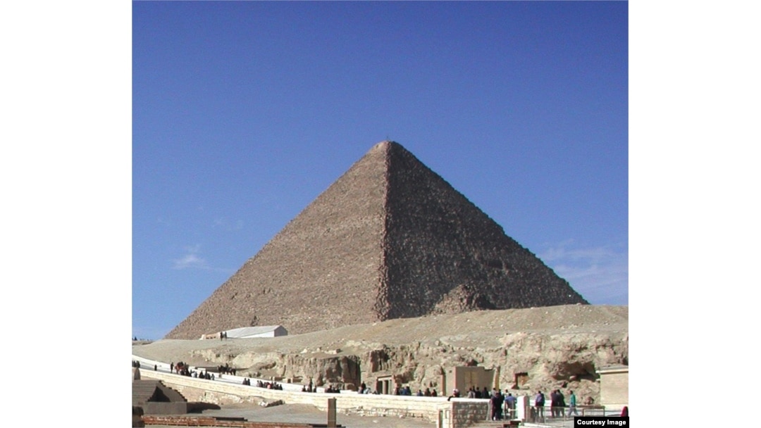 Tourists visiting one of the three main pyramids at the Giza necropolis outside Cairo. (D. Bekheet/VOA)