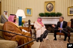 FILE - President Barack Obama meets with Saudi Arabia's Crown Prince Mohammed bin Nayef, center, and Deputy Crown Prince Mohammed bin Salman, left, in the Oval Office of the White House in Washington, May 13, 2015.