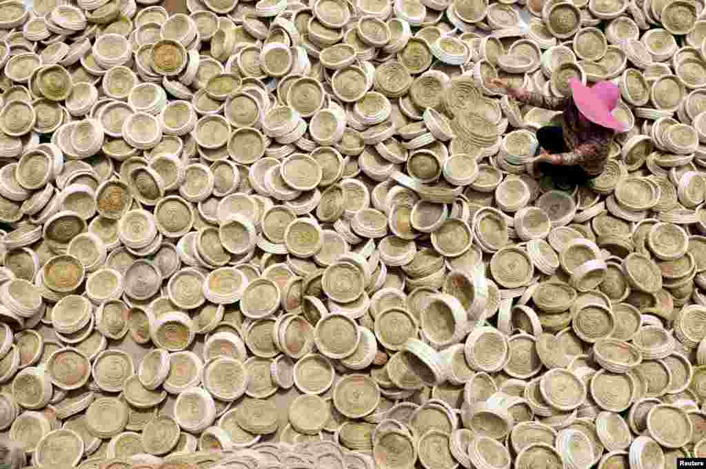 A worker puts aside bird nests in Linyi, Shandong Province, China.