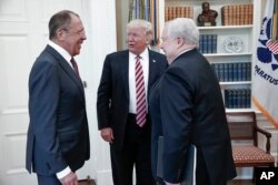 FILE - U.S. President Donald Trump meets with Russian Foreign Minister Sergey Lavrov, left, next to then-Russian Ambassador to the U.S. Sergei Kislyak at the White House in Washington, May 10, 2017. (Russian Foreign Ministry photo via AP)