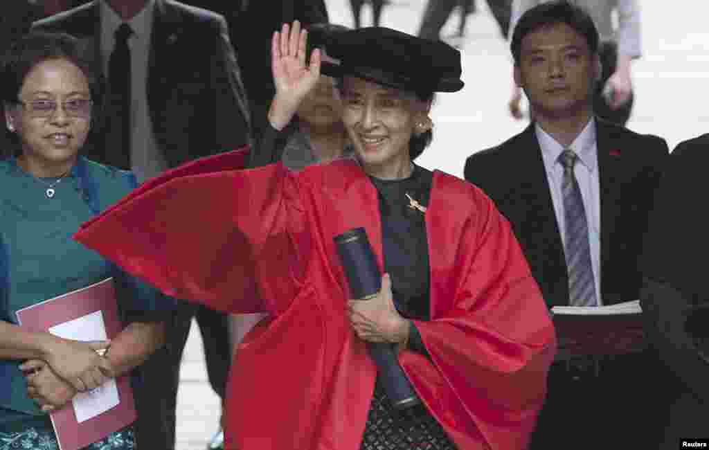 Burmese opposition leader leaves through The Great Gate after receiving her honorary degree at Oxford University, in Oxford southern England, June 20, 2012.