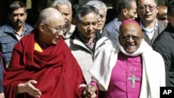 Tibetan spiritual leader Dalai Lama (L) and South African Archbishop and Nobel Laureate Desmond Tutu walk visiting a Tibetan temple in Dharamsala, India, February 10, 2012.