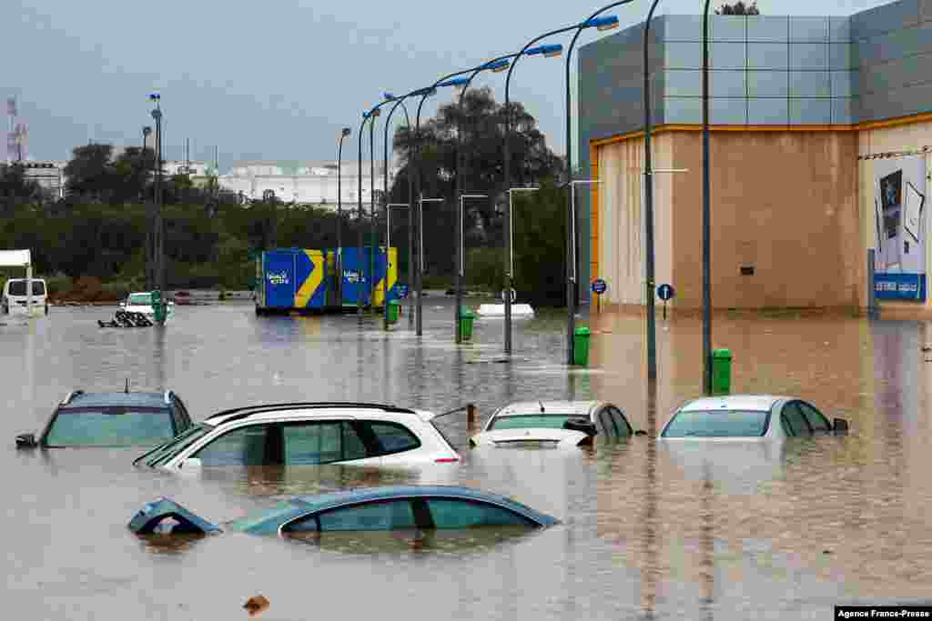 Cars submerge in a flooded parking lot outside a shopping center in Oman&#39;s capital Muscat.&nbsp;Bad weather has been affecting states around the Gulf, with several issuing weather warnings.