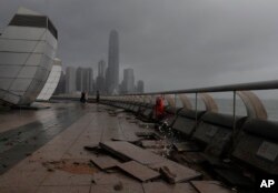Debris caused by Typhoon Hato damage is strewn across the waterfront of Victoria Habor in Hong Kong, Aug. 23, 2017.
