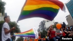 FILE - Participants attend the 5th annual LGBT pride parade in Hanoi, Vietnam, Aug. 21, 2016. East Timor, Asia's youngest nation, held its second LGBT pride parade July 21.