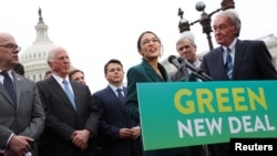 FILE - U.S. Representative Alexandria Ocasio-Cortez (D-NY) and Senator Ed Markey (D-MA) hold a news conference for their proposed Green New Deal to achieve net-zero greenhouse gas emissions in 10 years, at the U.S. Capitol in Washington, Feb. 7, 2019.