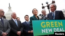 FILE - U.S. Representative Alexandria Ocasio-Cortez (D-NY) and Senator Ed Markey (D-MA) hold a news conference for their proposed Green New Deal to achieve net-zero greenhouse gas emissions in 10 years, at the U.S. Capitol in Washington, Feb. 7, 2019.