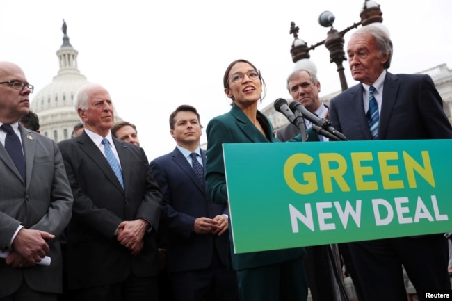 FILE - U.S. Representative Alexandria Ocasio-Cortez (D-NY) and Senator Ed Markey (D-MA) hold a news conference for their proposed Green New Deal to achieve net-zero greenhouse gas emissions in 10 years, at the U.S. Capitol in Washington, Feb. 7, 2019.