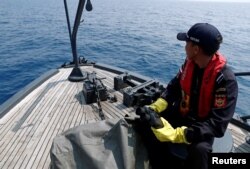 FILE - Indonesian customs officers patrol at a search area for Lion Air flight JT610 in Karawang waters, Indonesia, Nov. 1, 2018.