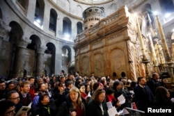 Christian worshipers attend Easter Sunday Mass in Jerusalem’s Holy Sepulcher Church, April 21, 2019.