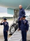President Joe Biden catches his balance as he walks down the stairs of Air Force One as he arrives at Detroit Metropolitan Wayne County Airport to join striking United Auto Workers on the picket line, Tuesday, Sept. 26, 2023, in Romulus, Mich. 