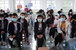 Residents wait at the observation area during a coronavirus disease (COVID-19) vaccination session for those aged between 12 and 14, in Heihe, Heilongjiang province, China, Aug. 3, 2021. (China Daily via Reuters)