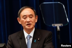 FILE - Japan's Prime Minister Yoshihide Suga speaks during a press conference in Tokyo, March 18, 2021.