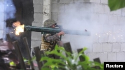 A soldier from the the Philippines Army's 2nd Mechanized Infantry Division fires a rocket launcher toward the positions of members of the Bangsamoro Islamic Freedom Fighters (BIFF) militants during clashes in Maguindanao, Philippines, July 4, 2018.