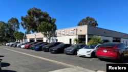 FILE - Several Tesla electric vehicles are parked in front of a Tesla service center in San Diego, Calif., Oct. 31, 2023.