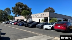 FILE - Several Tesla electric vehicles are parked in front of a Tesla service center in San Diego, Calif., Oct. 31, 2023.