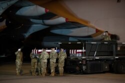 A U.S. Army carry team moves a transfer case containing the remains of Chief Warrant Officer 2 David C. Knadle, of Tarrant, Texas, who according to the Department of Defense died in Afghanistan, during a casualty return ceremony, Nov. 21, 2019.