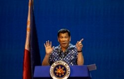 FILE - Philippine President Rodrigo Duterte gestures during the Partido Demokratiko Pilipino-LakasBayan (PDP-LABAN) meeting in Manila, May 11, 2019.