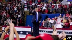 President Donald Trump points to the crowd after speaking during a campaign rally at UW-Milwaukee Panther Arena, Tuesday, Jan. 14, 2020, in Milwaukee.