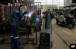 An employee works at a factory that produces Quantum electric cars, in Cochabamba, Bolivia, May 9, 2023.