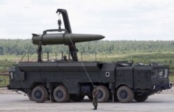 FILE - Russian servicemen equip an Iskander tactical missile system at the Army-2015 international military-technical forum in Kubinka, outside Moscow, Russia, June 17, 2015.