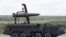 FILE - Russian servicemen equip an Iskander tactical missile system at the Army-2015 international military-technical forum in Kubinka, outside Moscow, Russia, June 17, 2015.