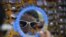 A Pakistani customer looks in a mirror before buying a pair of sunglasses from a roadside vendor in Islamabad.