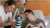 A handout photo taken on Sept. 28, 2014 by the parents of Vincent Lambert (R) and released by their lawyer Jean Paillot shows Vincent Lambert, a quadriplegic man on artificial life support, with his sister Marie Lambert (L) at a hospital in Reims. 
