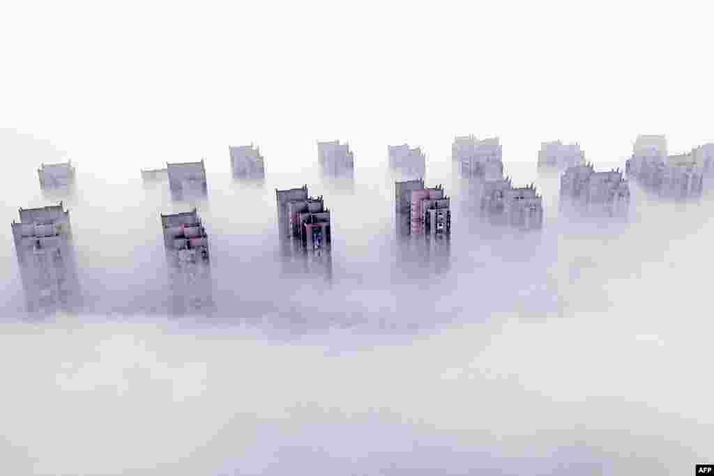 Residential buildings are shrouded in fog in Lianyungang, in eastern China's Jiangsu province.