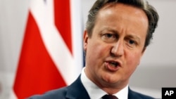 FILE - British Prime Minister David Cameron as he speaks during a media conference at the conclusion of the Eastern Partnership summit in Riga, Latvia. Cameron declared, July 19, 2015 that Britain needs to take a greater role in destroying the Islamic State group in Syria.