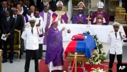 Bishop Joseph Lafontant incenses the coffin containing the remains of former President Rene Preval during his funeral service in Port-au-Prince, Haiti, March 11, 2017. 