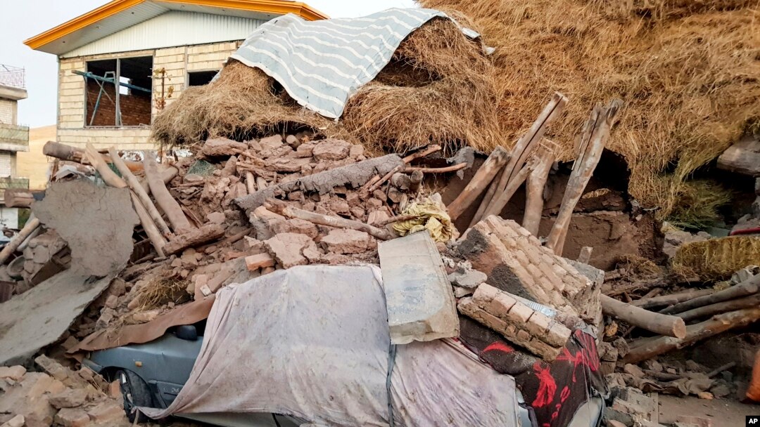 ایران کے مشرقی صوبے آذربائیجان میں زلزلے کی زد میں آنے والی ایک کار ملبے کے ڈھیر میں دبی ہوئی ہے۔ 
