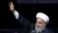 Iranian President Hassan Rouhani waves to the crowd during a rally marking the 39th anniversary of the 1979 Islamic Revolution, in Tehran, Iran, Sunday, Feb. 11, 2018. Hundreds of thousands of Iranians rallied on the streets Sunday to mark the anniversary, just weeks after anti-government protests rocked cities across the country. 