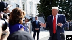 FILE - President Donald Trump talks to reporters on the South Lawn of the White House, Aug. 9, 2019, in Washington.