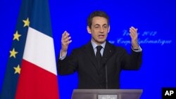 France's President Nicolas Sarkozy says he is suspending training operations in Afghanistan and threatening to withdraw the entire force from the country early, after an Afghan soldier shot and killed four French troops Friday and wounded several others, 