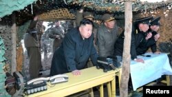 North Korean leader Kim Jong-Un (C) watches soldiers of the Korean People's Army (KPA) taking part in drills on March 25, 2013, in this picture released by the North's KCNA news agency.