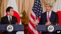 Japanese Foreign Minister Fumio Kishida listens as Secretary of State John Kerry speaks after a meeting at the State Department in Washington, Feb. 7, 2014. 