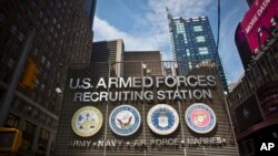 FILE - The Times Square military recruiting station displays insignia for each military branch in New York, July 15, 2015.