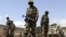 African Union (AU) soldiers patrol in front of their military base in the lower Shabelle region, outside Somalia's capital Mogadishu, July 3, 2012. 