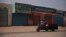 FILE - A man drives past shuttered shops after a military coup unseated the country 's civilian government, in Khartoum, Sudan, Oct. 28, 2021. 
