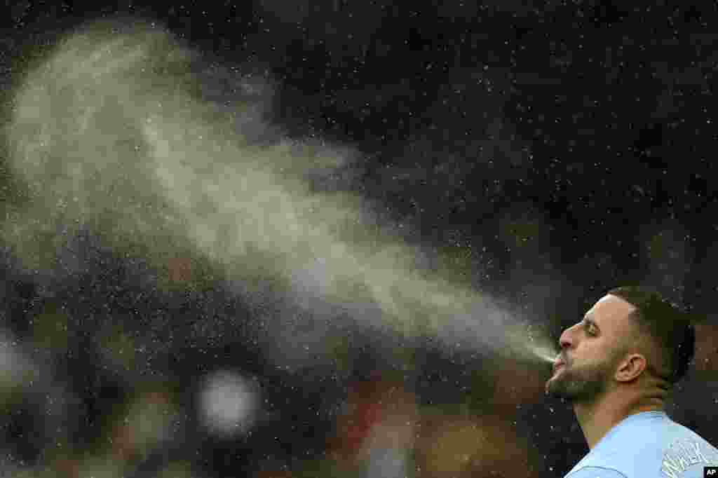 Manchester City&#39;s Kyle Walker completes his pre-match ritual of spitting water before the English Premier League soccer match between Manchester City and West Ham United at the Etihad stadium in Manchester, England.